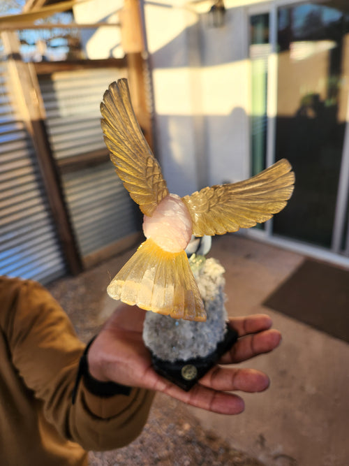 Rose Quartz and Yellow Calcite Bird carving on Agate Rose Perched on Crystal Geode with Onyx Base – A Symbol of Love, Clarity and Grounded Energy